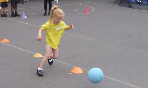 Girl kicking a football